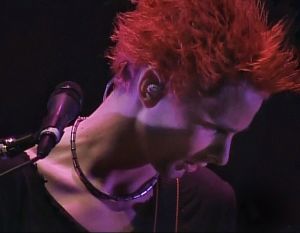 Bellamy singing on stage